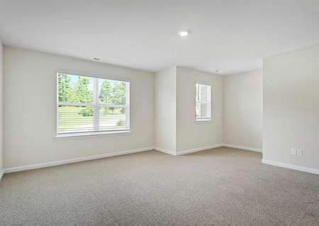 Master bedroom with carpet and large windows