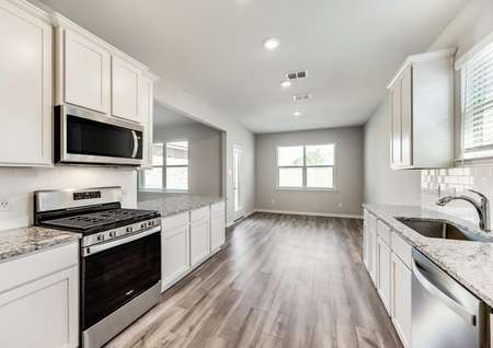 The kitchen is open to the dining room and features gorgeous wood-look flooring.