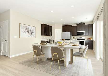 Open concept dining and kitchen with contemporary neutral colored furniture, sliding glass door and ceiling fan.