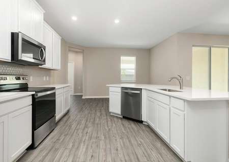Open kitchen with quartz countertops and all new kitchen appliances.