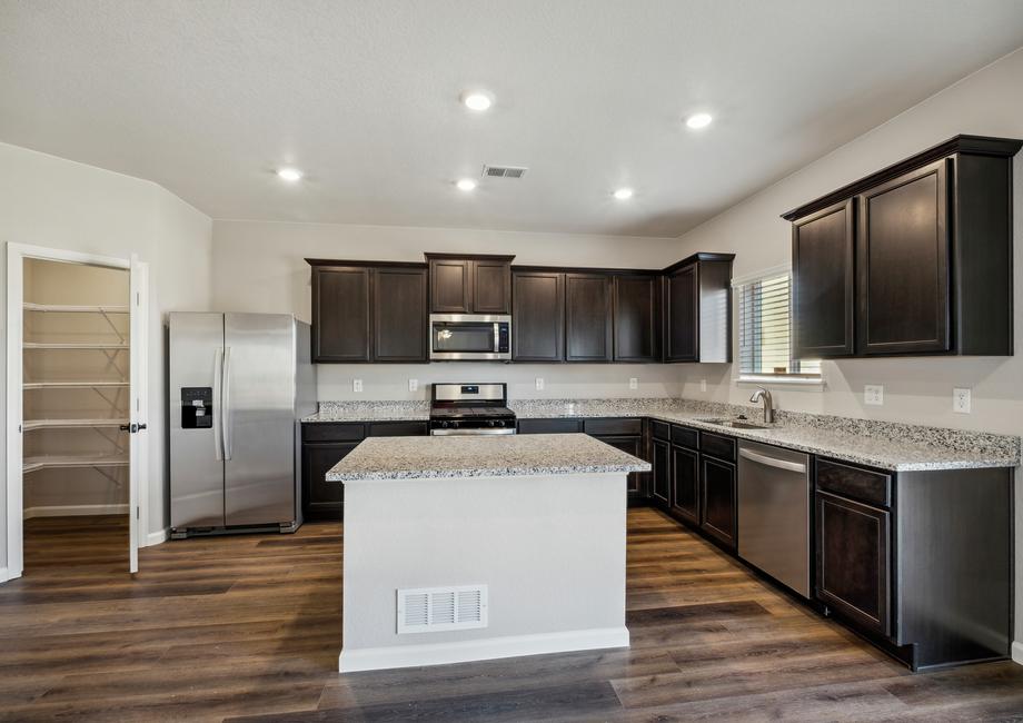 Chef-ready kitchen with an island and granite countertops.