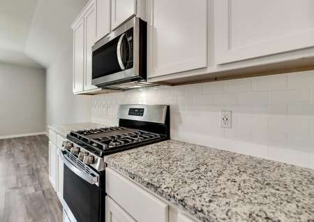 The kitchen comes complete with stunning, white cabinetry and a full suite of stainless steel appliances.
