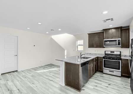Open, chef-ready kitchen with beautiful stainless steel appliances and granite countertops. 