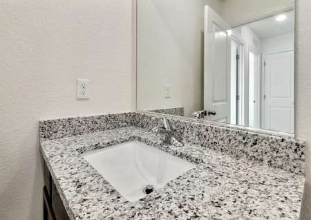 Guest bathroom with a granite countertops and espresso cabinets.