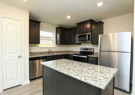 Blanco kitchen with granite countertops and stainless appliances