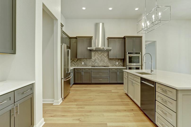 The chef-ready kitchen has stainless steel appliances and stunning wood cabinetry.