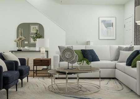 Rendering of living area with view
  adjacent to staircase with round coffee table and side table.