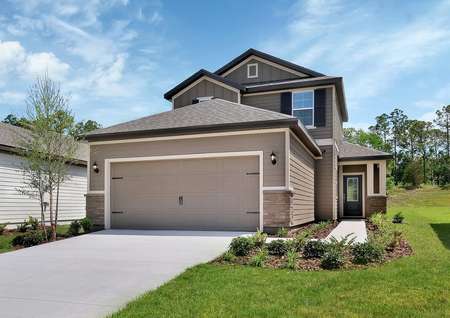 Large, two-story home with a two-car garage, a covered entryway and brown siding. 