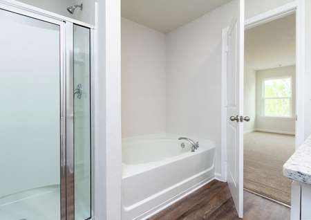 The Hartwell master bathroom features a garden tub and walk-in shower.
