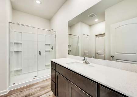 The master bath has a huge glass enclosed shower and beautiful vanity.