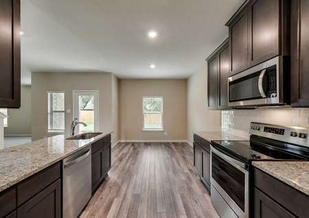 Ozark kitchen with dark wood cabinets, wood vinyl flooring, and granite countertops 