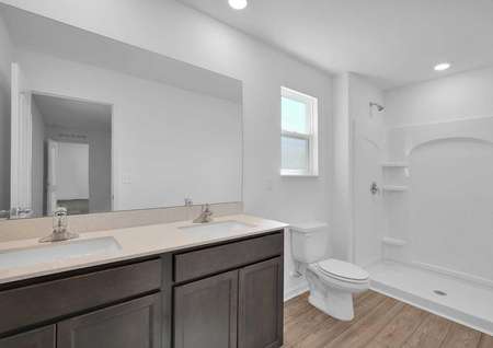 The master retreat features its own full bathroom with double sinks. 