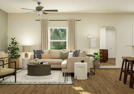 Rendering of
  living room with window and ceiling fan, decorated with a tan sectional
  couch, round coffee table, accent chair and media center.