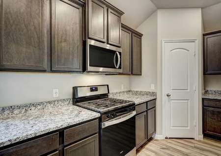 The kitchen has a full suite of stainless steel appliances.