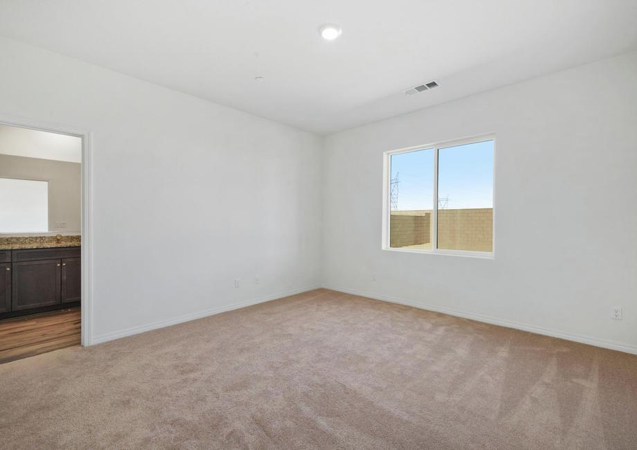 The master bedroom is spacious and has a large window.