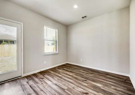 The dining room offers great natural light and wood-style flooring.