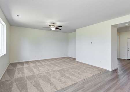 Spacious family room with carpet and a ceiling fan