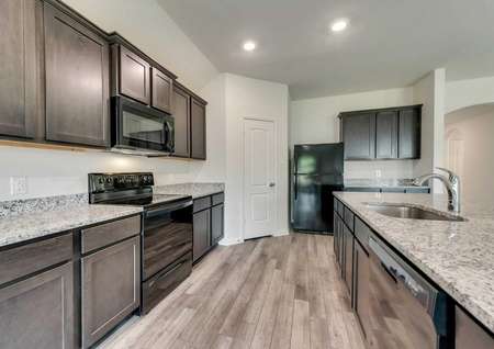 Topeka plan's upgraded kitchen with new all black appliances.