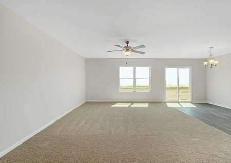 Allatoona living room with large window, patio door, and carpet-wood floors
