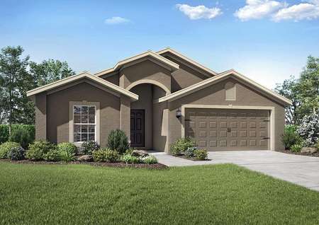 Exterior view of the Estero floor plan model with a two-car garage and a beautifully landscaped front yard.