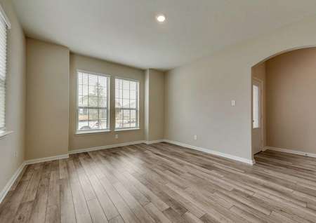Ontario front room with large white-frame windows, wood-look flooring and ceiling light