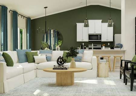 Rendering of the
  living area featuring a large white sectional, accent chairs, and coffee
  table with a view of the kitchen in the background.