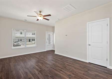 The family room has dark wood-style flooring and a ceiling fan.