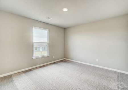 Spacious secondary bedroom features recessed lighting and a large window. 