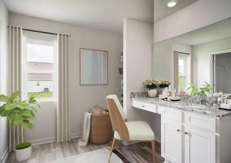 Staged master bathroom with vanity stool, decorated vanity and plants.