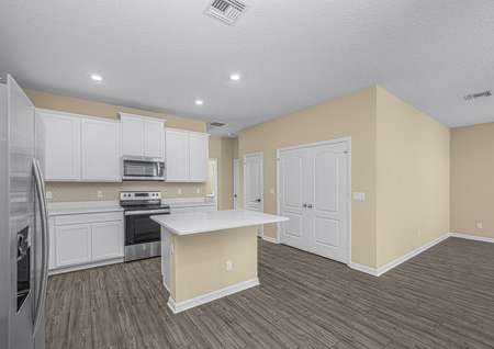 The kitchen has a island and ample storage opportunities