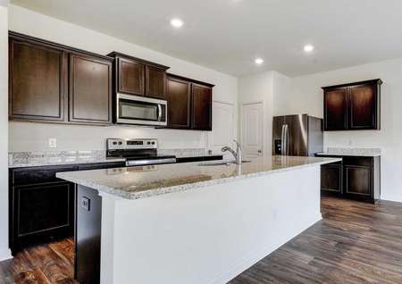 Rio kitchen with granite countertops, wood cabinets, and modern stainless steel appliances