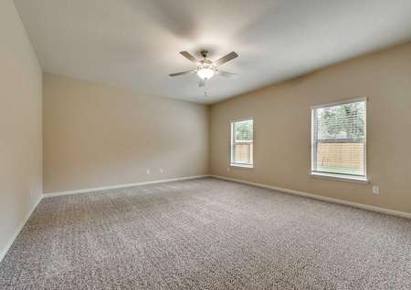 Ozark large living room with two windows, ceiling fan with light kit and carpet