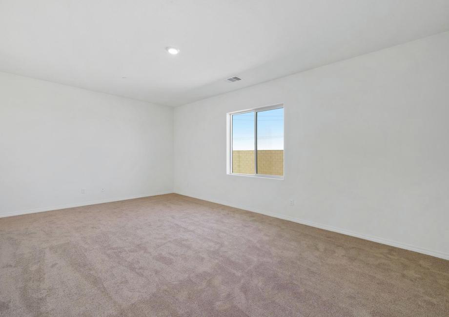 The master bedroom is spacious and has carpet.