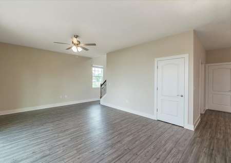 Spacious family room with luxury vinyl plank flooring and plenty of natural light.