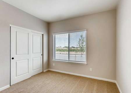 San Juan bedroom with grey walls with white trim, sliding closet doors, and window with blinds