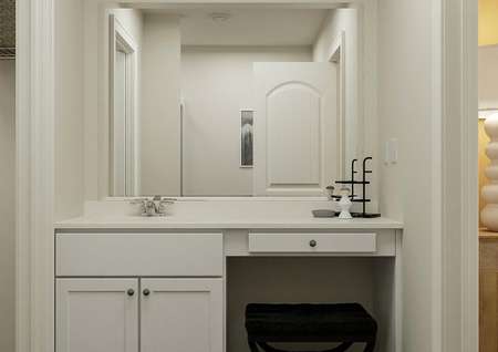 Rendering of the master bath focused on
  the sink, make-up vanity and white cabinetry. The mirror reflects that
  bathtub. 