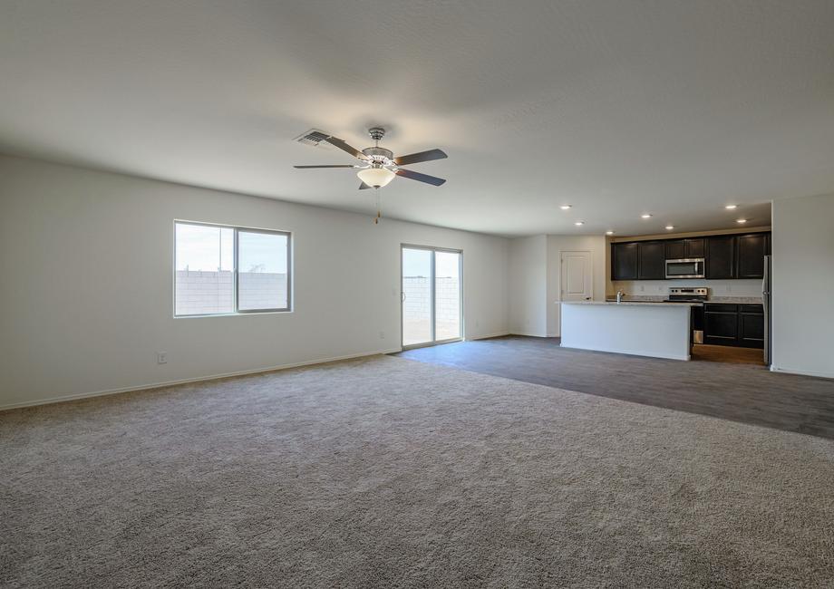 Spacious family room with an open-concept allowing a view of the stunning kitchen.