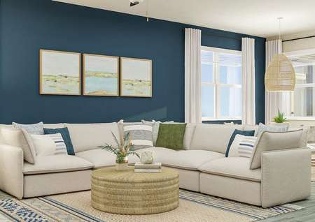 Rendering of living room showing a white
  sectional couch, a round coffee table, and decor all along a blue accent wall
  and abstract art with a dining set in the background and wood look flooring
  throughout.