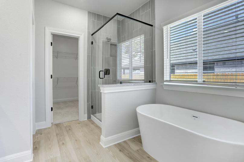 Master bathroom with a large walk-in shower and separate soaking tub.
