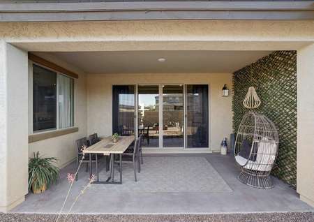 Mead backyard covered patio with furniture, concrete floor, and sliding glass door