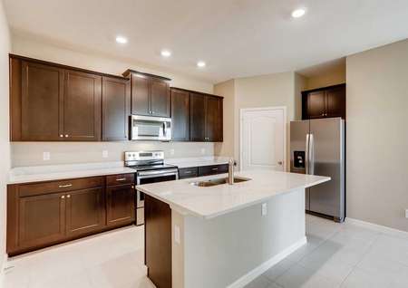 The Santa Maria model home's spacious kitchen. Quartz countertops, stainless steel appliances, tile flooring, upgraded cabinetry and recessed living