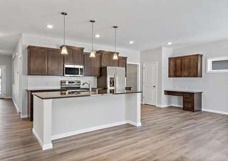 Photo of open kitchen with island, decorative pendant lighting, brown cabinets, stainless steel appliances and luxury plank flooring.