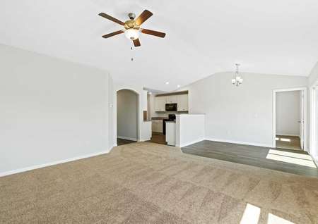 Alamance great room with brown carpet, wood flooring, and off white walls