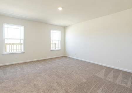 Spacious owner bedroom with carpet, two windows, recessed lighting.