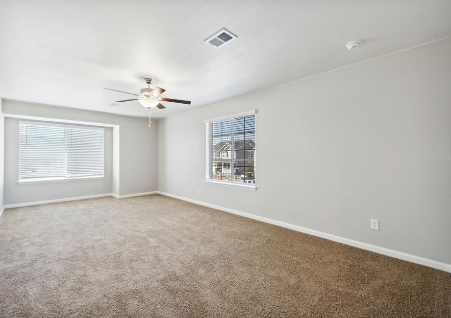 Expansive master bedroom with a box seat creates an inviting space.