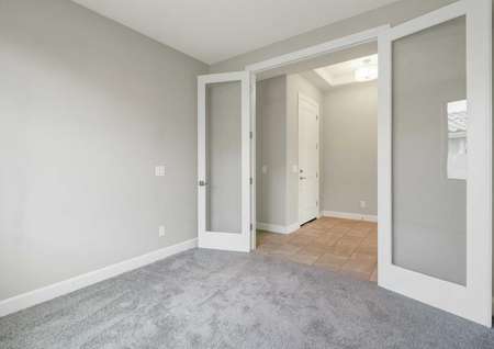 Hawley finished floor plan with carpeted floor, French style glass doors with wood frame, and grey walls