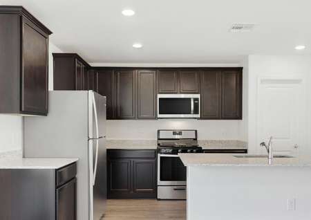 Stunning kitchen with stainless appliances, granite countertops and wood-style flooring.