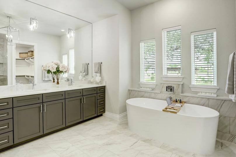 Master bath with double-sink vanity and soaking tub.