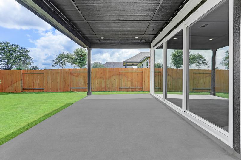 Covered back patio with direct access to the living room through the large sliding glass doors.