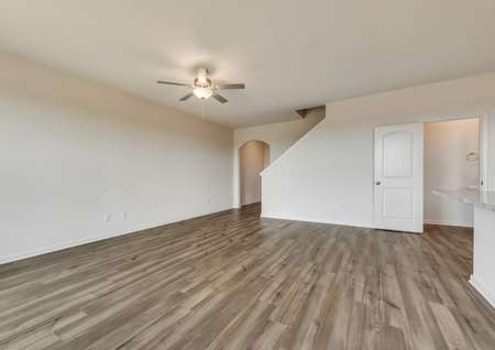 The family room has a ceiling fan and luxury vinyl plank flooring.